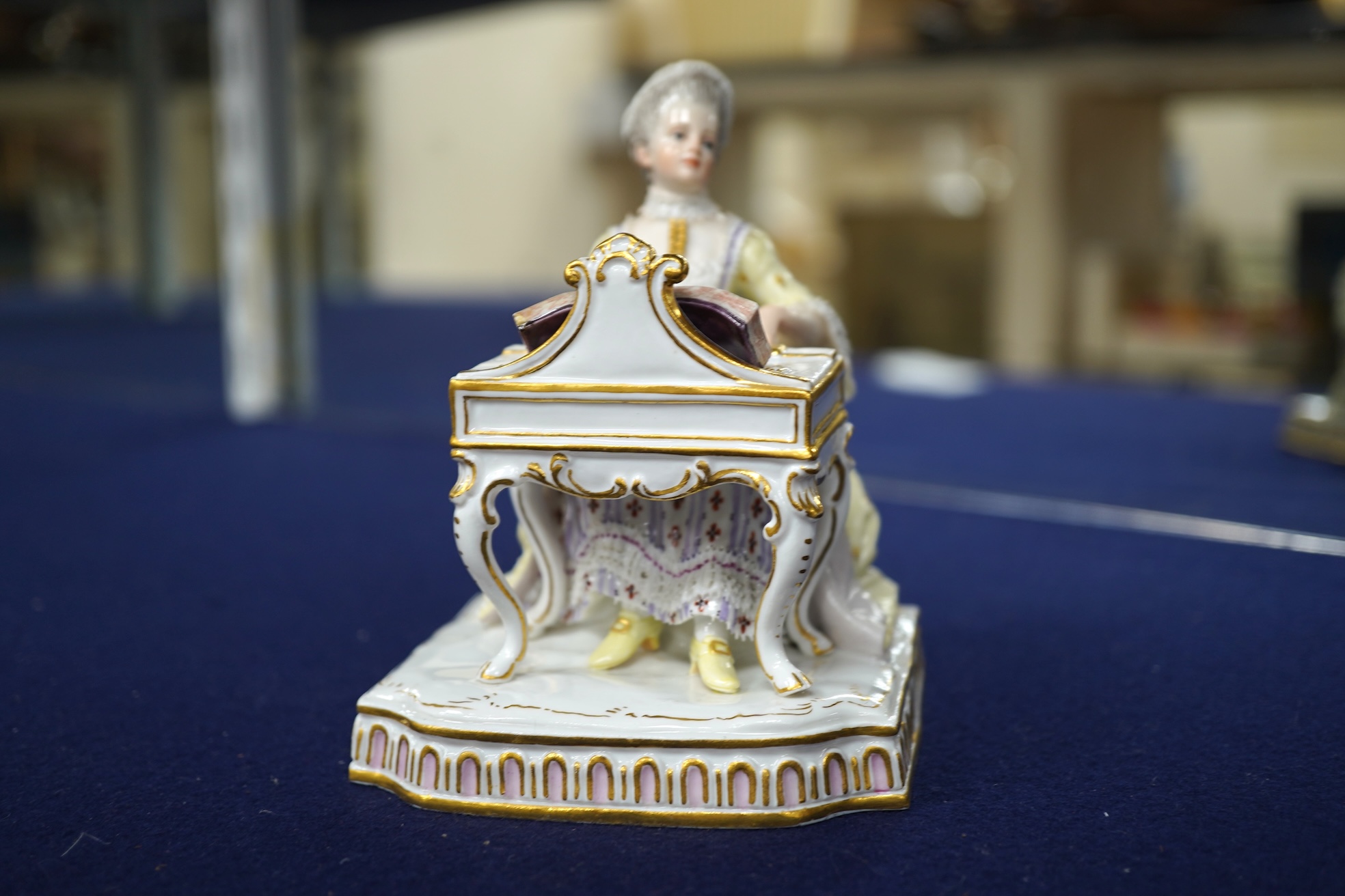A pair of 19th century Meissen figures of a girl holding a shell and a boy holding a book, in size model number 628, tallest 13cm